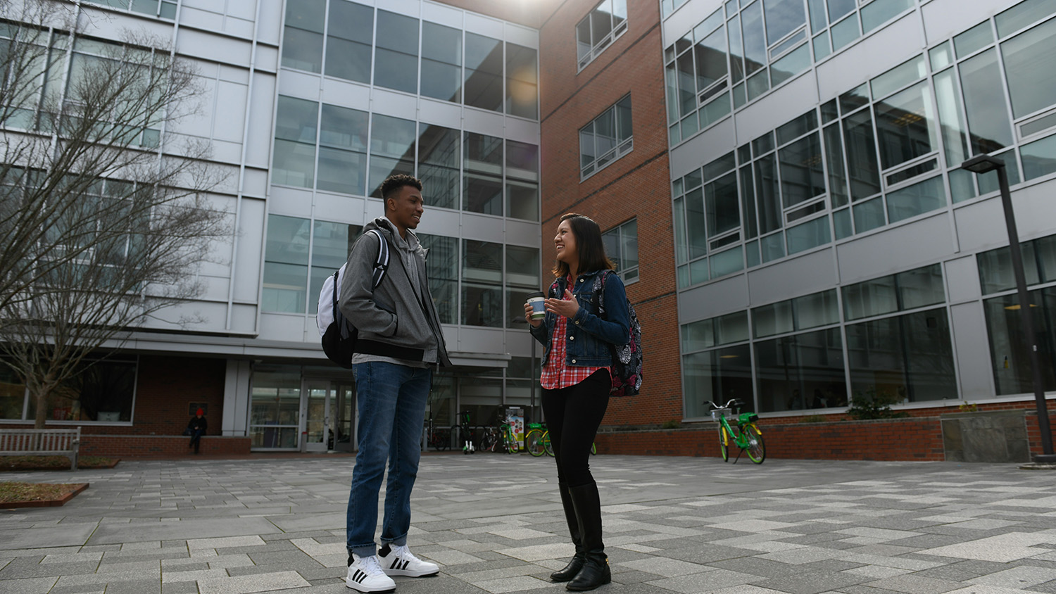 Two students talk in front of SAS Hall