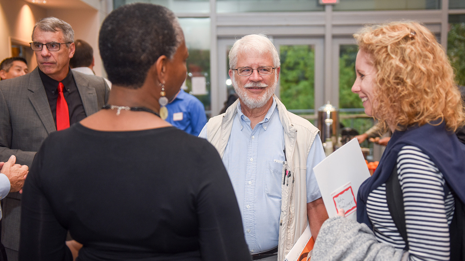 People talk at a reception during the Statistics 75th anniversary celebration