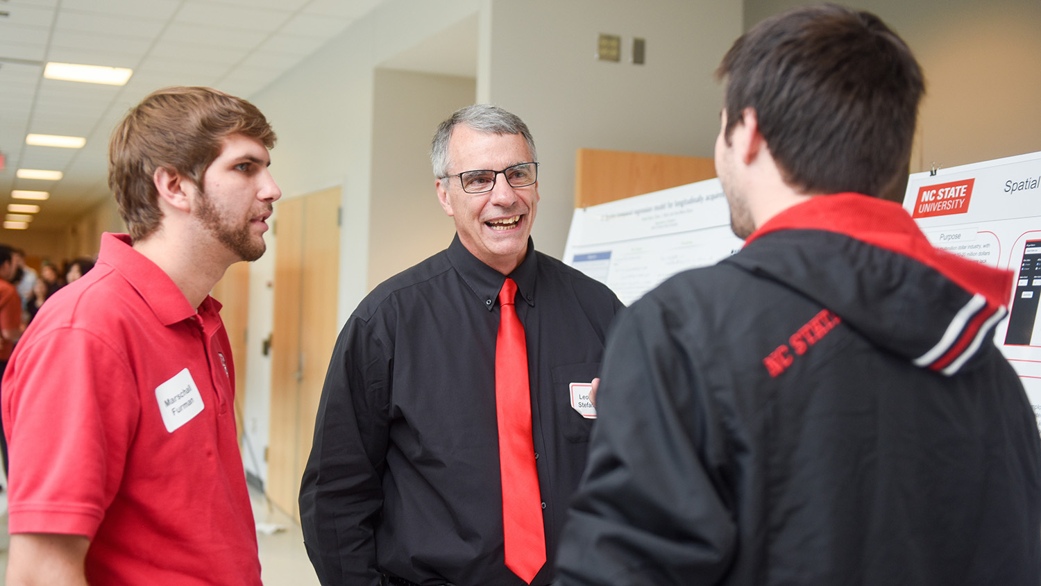 Len Stefanski talks with two students